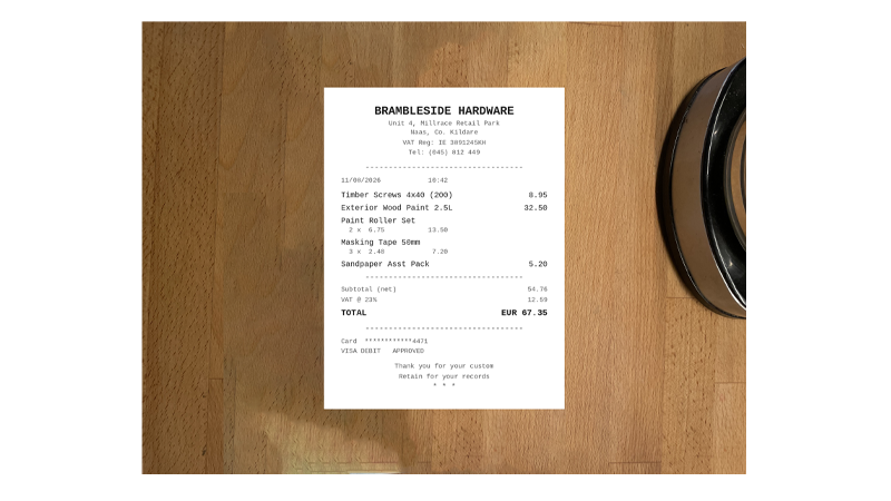A phone photographing a paper receipt to attach to an expense